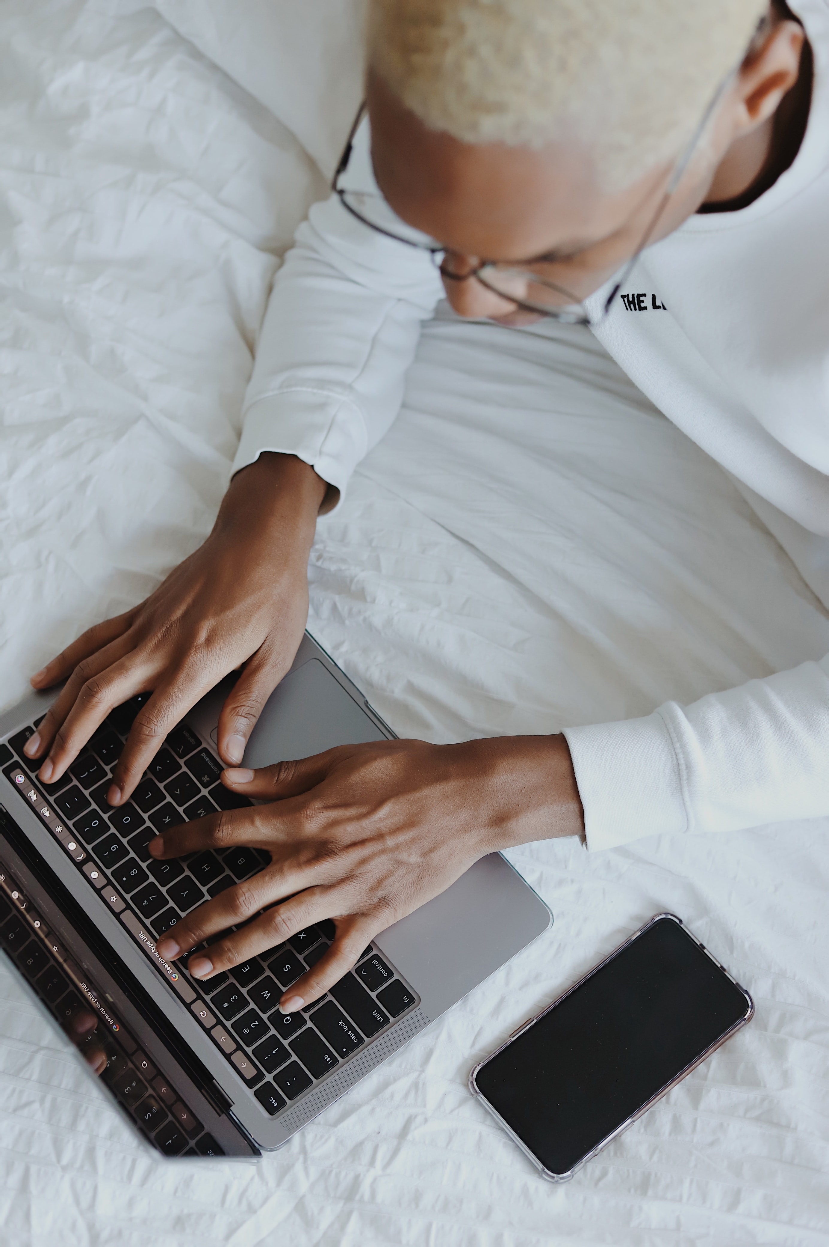 Hands typing on a laptop computer