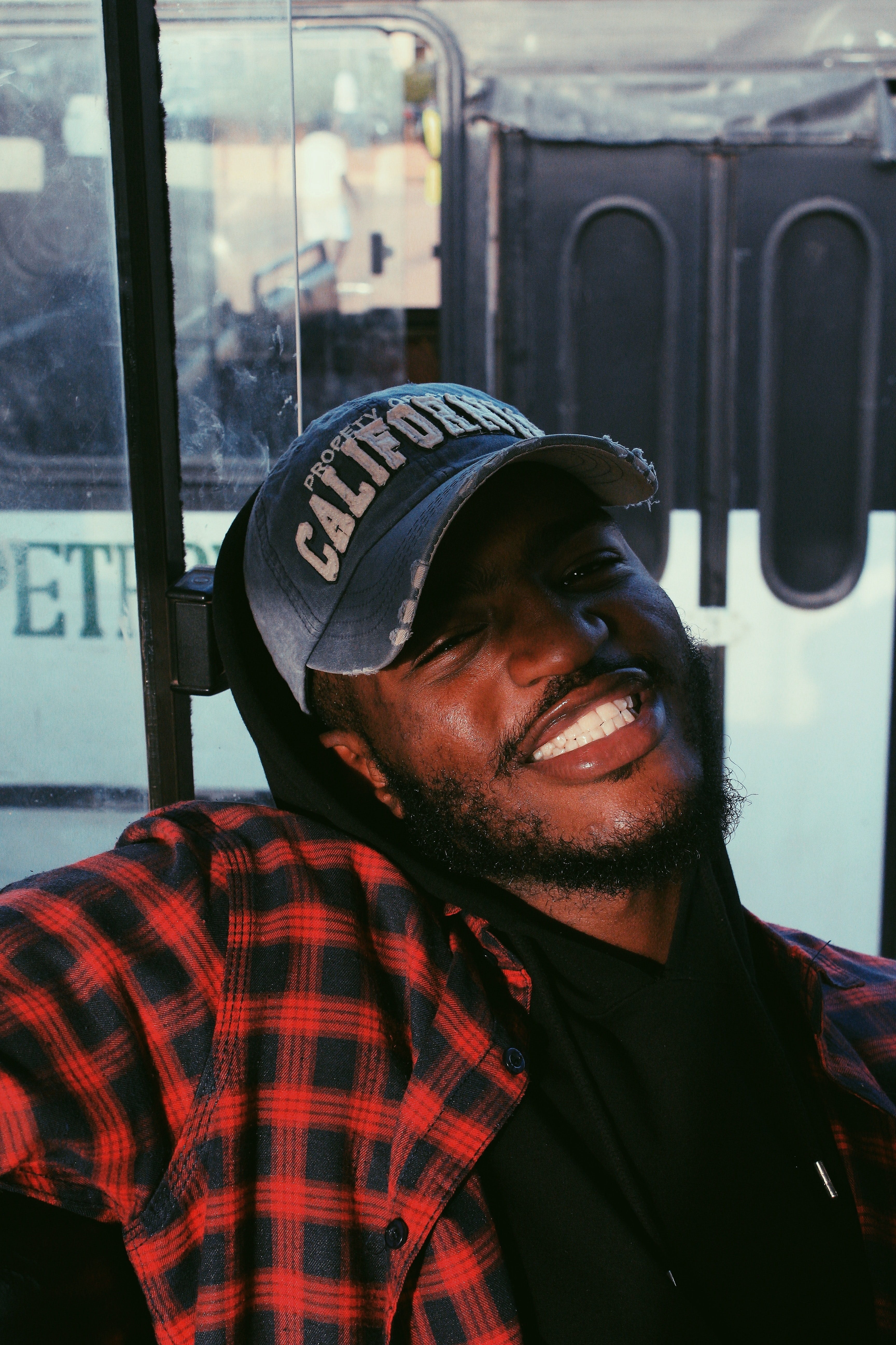 Man wearing a blue baseball cap smiling